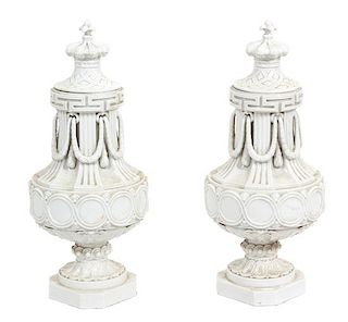 A Pair of Continental White Ceramic Covered Urns Height 27 inches.