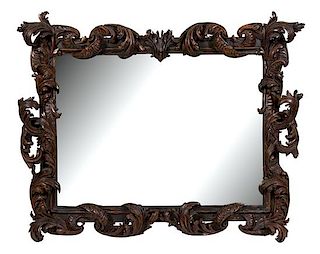A English Carved and Ebonized Mirror Frame Height 60 x width 70 inches.