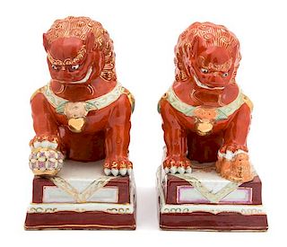 A Pair of Porcelain Foo Dogs Height 9 3/4 inches x width 5 inches.