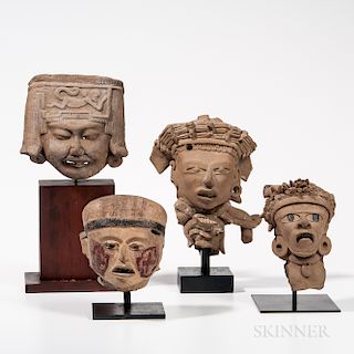 Four Veracruz Head Fragments, late classic period, 550-950 AD, including a smiling head with spider monkey molded on the headdress, an