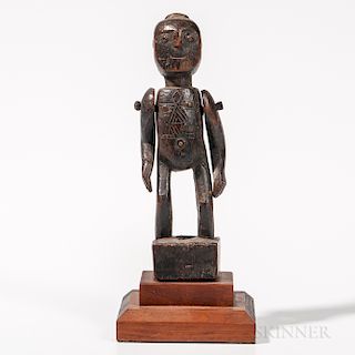 Timor Female Figure, with no feet, standing in a block with bent legs, rounded torso and arms attached by wood pegs, glass bead eyes, t