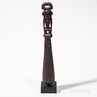 Wooden Food Pounder, Schouten Islands, Papua New Guinea, mid-20th century, male ancestor figure atop the long pounder, overall black pa