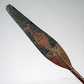 Ramu River Canoe Paddle, Papua New Guinea, with stylized fish and crocodile motifs decorating the blade, and a finely carved crocodile