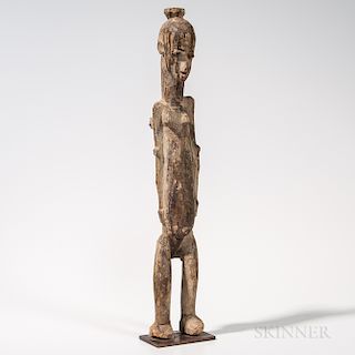 Lobi Maternity Figure, with long straight legs, an elongated torso, arms straight at sides, with small pointed breasts, an elongated ne