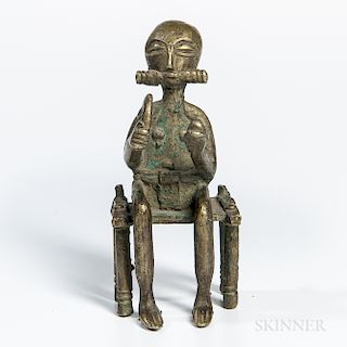 Bronze Seated Figure of a Chief, Baule, seated figure holds a curved knife in one hand and a head in the other, with inventory number "