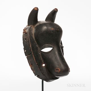 Baule Face Mask, water buffalo form, the head framed by a deep collar pierced for attachments, long snout, with heavy lidded cutout eye