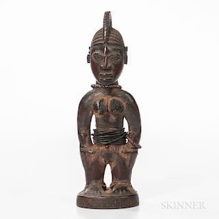 Female Yoruba Ibeji Figure, standing on a circular base, with flattened feet, legs set apart with the arms detached from the body and h