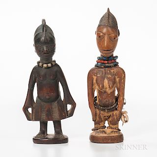 Male and Female Yoruba Ibeji Figures, each standing on a circular base with flattened feet and incised toes, the angular shoulders belo