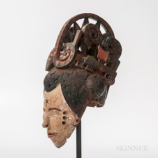 Ibo Maiden Spirit Helmet Mask, Agbogho Mmuo, the hollowed-out helmet form pierced around the rim for attachment of a cloth head coverin