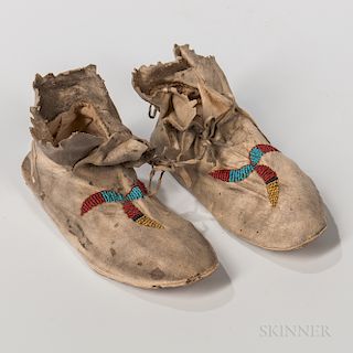 Apache Beaded Hide Child's Moccasins, c. 1880s, raw-hide leather soles, soft leather uppers, with simple beaded design on each moccasi