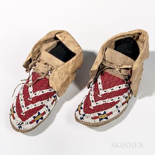 Western Sioux Beaded Hide Moccasins, c. 1880, resolved moccasins with flaps decorated on the upper part by lazy-stitch beads organized