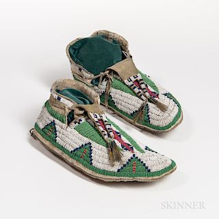 Pair of Plains Beaded Moccasins, Lakota, fourth quarter 19th century, with geometric in mainly blue and green on white background, with