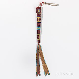 Cheyenne Beaded Awl Case, c. late 19th century, the commercial leather case and hide suspensions beaded in a striped design using multi