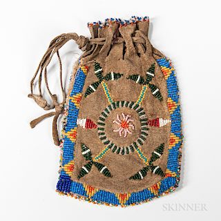 Plains Beaded Hide Bag, fourth quarter 19th century, drawstring hide bag beaded on both sides, lg. 7 3/4 in.Provenance: Private collect