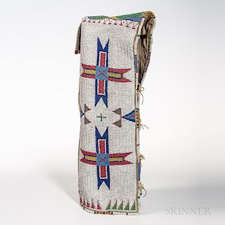 Plains Hide Beaded Cradle, Lakota, fourth quarter 19th century, the rawhide tab with differing multicolored geometric designs, the body
