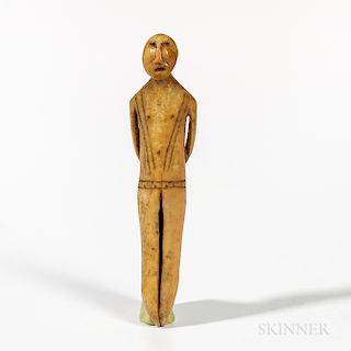Eskimo Figure, Alaska, late Punuk or Thule, the figure stands straight with cutout arms held behind the back, incised lines decorate th
