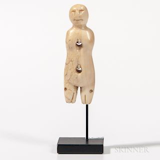 Eskimo Toggle Figure, Alaska, 19th century, human figure with seal heads for legs, two holes pierced for attachment to a garment, ht. 2
