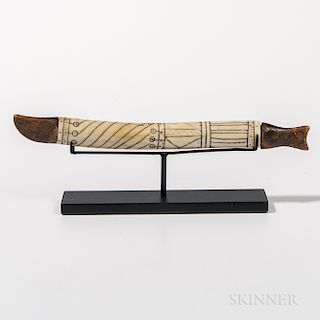Eskimo Needle Case, Alaska, 19th century, wood ends, bone tube, in the form of a fish with blackened incised designs, lg. 6 1/4 in.Prov