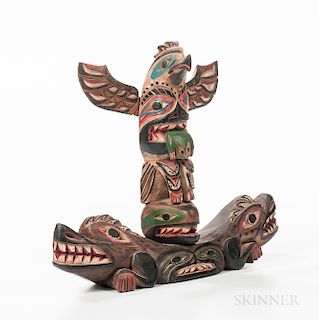 Haida Wood Model Totem Pole, the lozenge-form base carved in the form of opposed totemic creatures, surmounted by a small totem with a