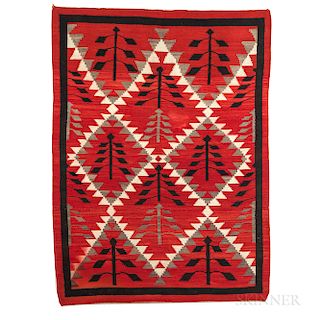 Large Navajo Rug, c. 1930s, with repeated tree motif design, black border, and red ground, (some dye run), 79 1/2 x 58 1/2 in.