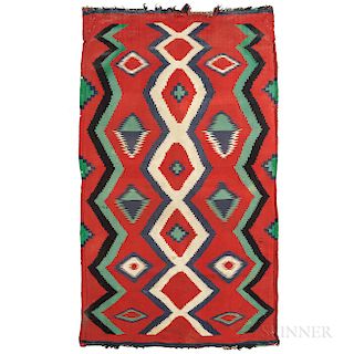 Navajo Transitional Rug, c. 1900, homespun wool, multicolored "eye dazzler" pattern on a red background, with fringe either end, (stain