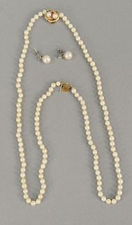 Woman's double strand pearl necklace with 14 karat gold clasp along with a pair of pearl earrings having diamond stud and pearl drop.