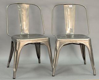 Eight industrial style metal stacking chairs.