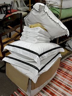 Lot of sheets and pillows.