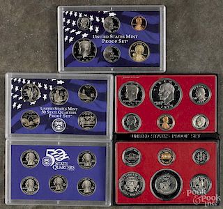 Four United States proof sets, to include examples from 1977, 1979, 2003 (quarters), and 2005.