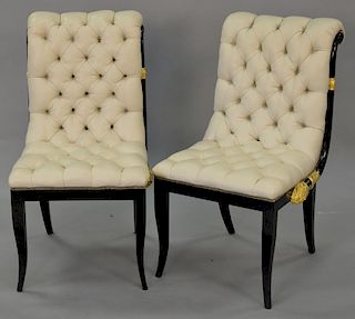 Pair of French style black and gilt chairs with white leather tufted seats and backs, seat
height 17.5 inches.