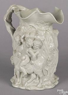 Salt glaze stoneware pitcher, 19th c., with a high relief bacchanal scene, 10 3/4'' h.