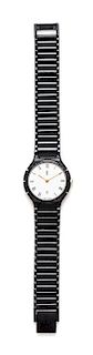 * An Yves Saint Black Quartz Wristwatch, 7" L x .5" W; Face: 1" diameter.