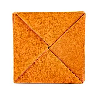 An Hermès Orange Leather Zulu Coin Purse, 3.25" x 3.25".