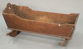Primitive cradle with highly scalloped top, 18th century. lg. 43 1/2 in.