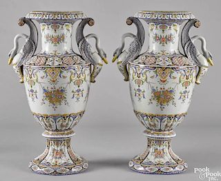 Pair of Continental faience urns, early 20th c., with swan-form handles, 27'' h.