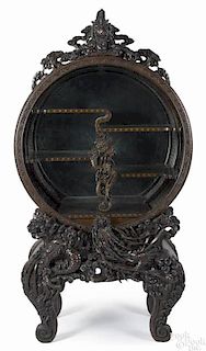Chinese carved display cabinet, early 20th c., with a rotating tambour action opening, 72'' h.