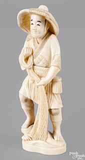 Japanese carved ivory figure, ca. 1900, of a man with a fishing net, 5 3/4'' h.
