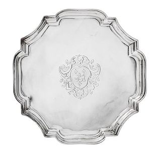 * A George I Silver Salver, John Tuite, London, 1727, the piecrust rim centered by an engraved shield crest and raised on four v