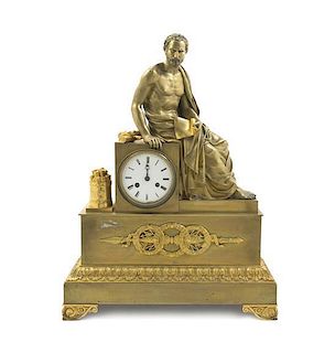 A French Empire Gilt Bronze Mantel Clock, Height 22 1/4 inches.