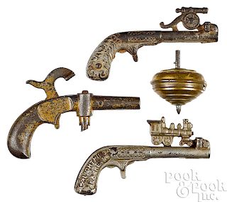 Three cast iron animated cap guns