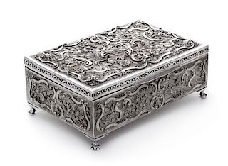 A Portuguese Silver Box, Late 19th/Early 20th Century, of rectangular form with allover repousse decoration, opening to a velvet