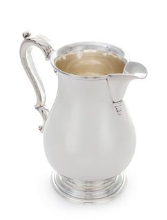 An American Silver Water Pitcher, International Silver Co., Meriden, CT, having a foliate capped handle.