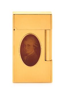 An S.T. Dupont Mozart: Medallion Limited Edition Line 2 Gold-Plated Pocket Lighter Height 2 1/2 inches.