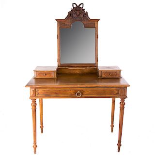 Tocador. Francia. Siglo XX. Estilo Enrique II. En talla de madera de nogal. Con espejo mixtil’neo biselado.