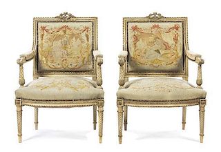 A Pair of Louis XVI Style Painted and Parcel Gilt Fauteuils, Height 37 inches.
