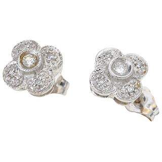 A diamond 14K white gold pair of stud earrings.