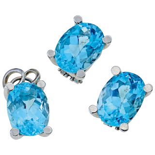 A topaz 14K white gold pendant and pair of earrings set.