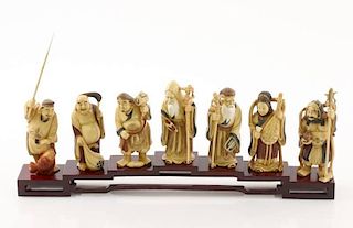 7 Faux Ivory Polychromed Buddhist Immortals, Stand
