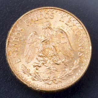 Moneda 2 pesos. Elaborada en oro amarillo de 21.6k. Ligero desgaste en el canto. Peso: 1.9g.