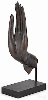Hand of Buddha Thai blessing sculpture, iron, filled and mounted on stand, 14 3/4" h., 6 1/2" w.